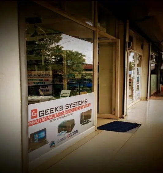 Exterior view of GeeksSystems computer sales and service store in Kunnamkulam, showing the physical shop location and branding.