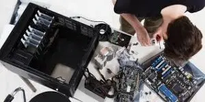 Technician assembling custom desktop PC with computer components and hardware parts