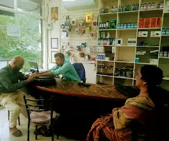 Customers visiting a computer and laptop accessories shop with shelves of electronic products
