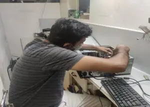 Computer technician repairing and servicing a desktop computer